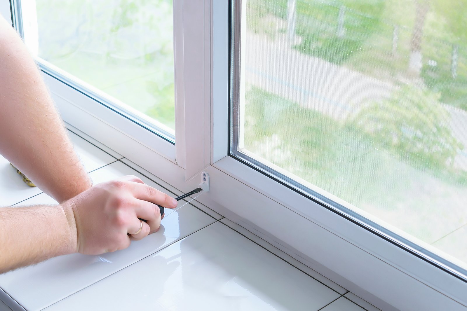 Checking for cold draughts around the seals of a uPVC window